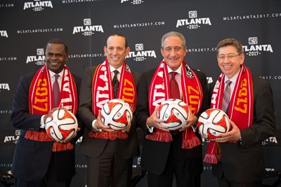 Apr 16, 2014; Atlanta, GA, USA; Atlanta mayor Kasim Reed (left), MLS commissioner Don Garber (second from left), team owner Arthur Blank (second from right), and Georgia World Congress Center executive director Frank Poe pose with soccer balls following the announcement of an MLS expansion team in Atlanta at Ventanas. Mandatory Credit: Kevin Liles-USA TODAY Sports